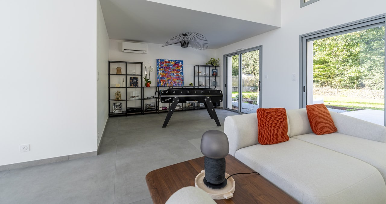 Salle de jeux avec baby-foot dans une maison familiale contemporaine construite aux Sables d’Olonne en Vendée