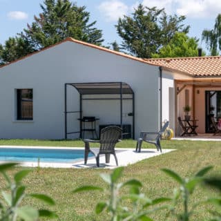 Architecture traditionnelle et tuiles en toiture pour cette maison neuve à Saint-Romain-de-Benet (17). Fonctionnelle avec 3 chambres, 2 salles de bain.