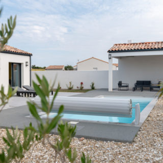 Façade arrière de maison plain-pied avec terrasse et piscine à Angles
